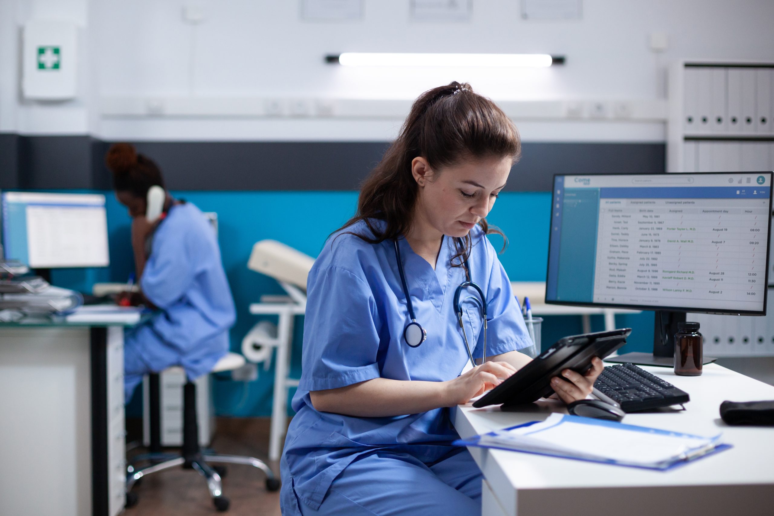 Young,Nurse,Checking,Appointments,List,On,Digital,Tablet,In,Busy